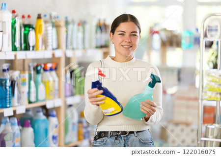 Woman choosing a cleaning spray 122016075