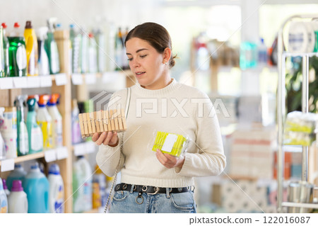 woman chooses clothespins for her home 122016087