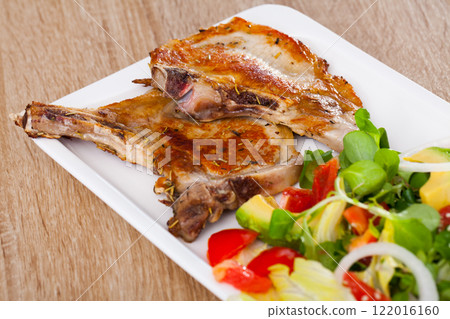 Grilled pork chop with salad 122016160