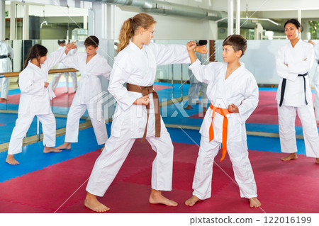Teenager children practicing new self defense moves Teenager children practicing new self defense moves 122016199