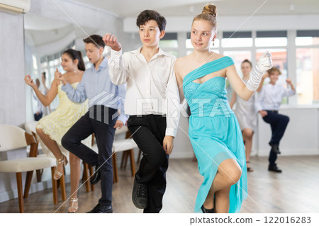 Boy and girl dancing twist in studio Boy and girl dancing twist in studio 122016283