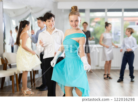 Elegant teenage girl and boy curtseying and bowing after dance performance 122016298