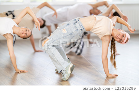 Teenage girl practicing hip-hop floor-works in training hall 122016299