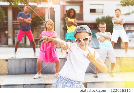Children exercising contemporary dance moves outdoors Children exercising contemporary dance moves outdoors 122016315