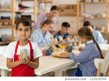 Little boy standing in art studio 122016344