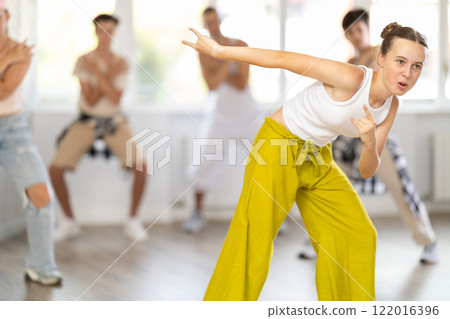 Teenage girl dancing hip hop in group 122016396