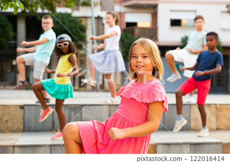 Group of kids performing street dance outdoors Group of kids performing street dance outdoors 122016414