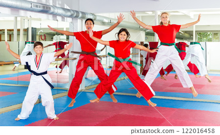 Children jumping with instructor at gym Children jumping with instructor at gym 122016458