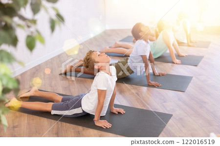 Group of multiethnic children doing yoga in studio 122016519