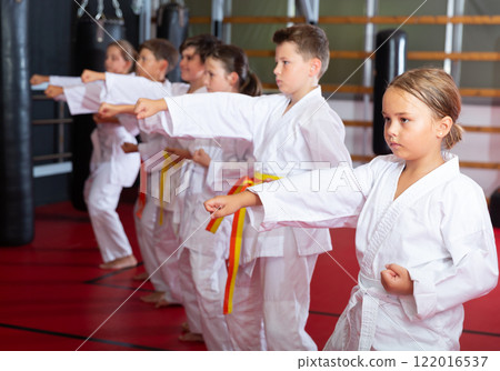 Group of girls and boys in kimono doing kata Group of girls and boys in kimono doing kata 122016537