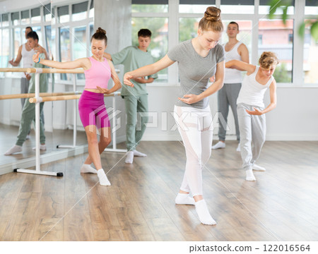 Teenage girl practicing ballet positions in dance studio Teenage girl practicing ballet positions in dance studio 122016564