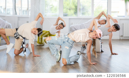 Teenage girl dancing breakdancing in group 122016566