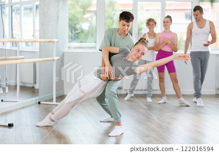 Boy and girl in pair train to perform ballet dance during rehearsal in studio Boy and girl in pair train to perform ballet dance during rehearsal in studio 122016594
