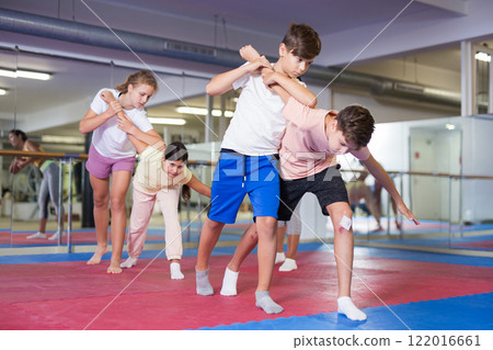 Kids learning self-defence moves in gym 122016661