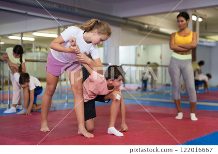 Young boys and girls learning self-protection moves Young boys and girls learning self-protection moves 122016667