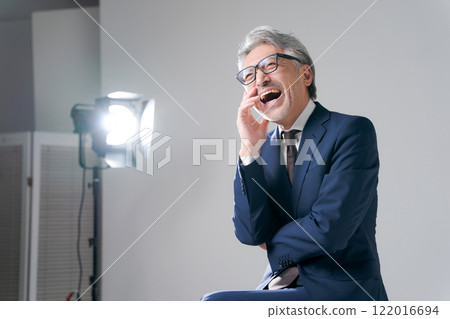 A man in a suit being photographed 122016694