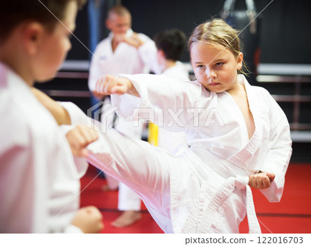 Kids sparring during karate training 122016703
