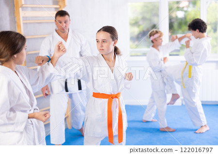 Young pupils train to perform defensive karate installations and attacking combat techniques Young pupils train to perform defensive karate installations and attacking combat techniques 122016797