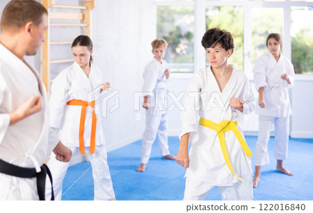 Preteen children during karate training. Martial arts. Sport, active lifestyle concept 122016840