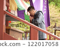 Senior man praying at a temple 122017058