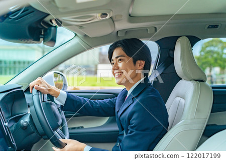 A man driving a car 122017199