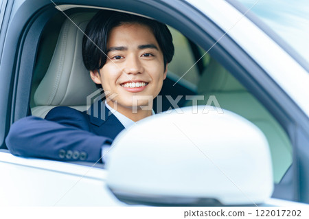 A man driving a car 122017202