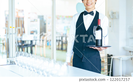 man carrying wine bottle and wine glass 122017257