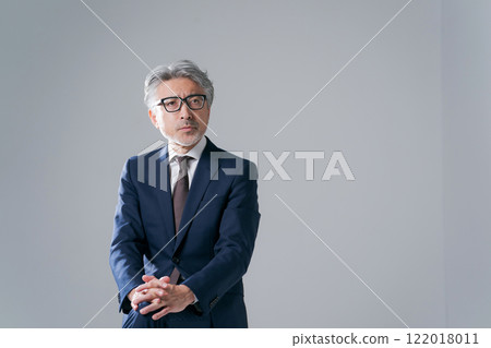 man in suit sitting on chair 122018011
