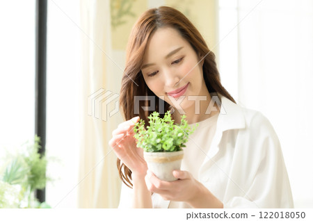 A woman looking at houseplants 122018050