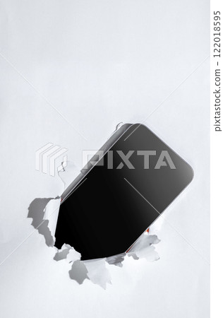 Blank mobile phone from the hole of ripped paper. Mockup or Copy space. Template. Concept of technology or communication Blank mobile phone from the hole of ripped paper. Mockup or Copy space. Template. Concept of technology or communication 122018595