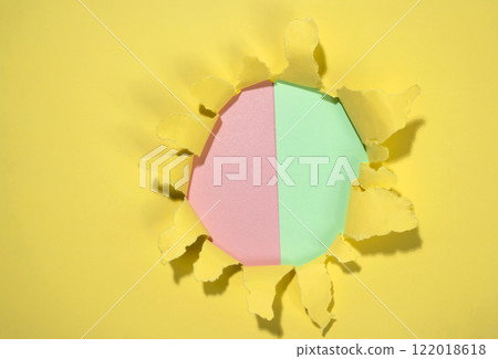 Top view of the hole from ripped yellow paper with a colored background. Mockup. Copy space. Presentation or template. Flat lay 122018618