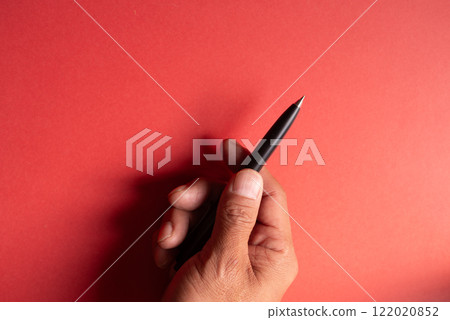 Person holding a ballpoint pen Person holding a ballpoint pen 122020852