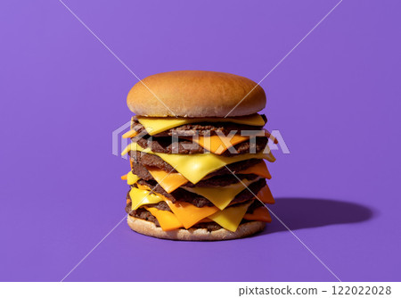 Big cheeseburger with beef and cheese, isolated on a purple background. 122022028