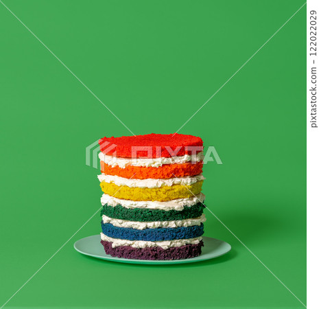 Buttercream cake, rainbow colors batter, minimalist on a green background 122022029