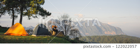 landscape and travel concept with asian man relax see sunset camping tent on mountain landscape and travel concept with asian man relax see sunset camping tent on mountain 122022057