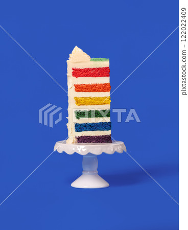Rainbow cake slice isolated on a blue background. Rainbow cake slice isolated on a blue background. 122022409
