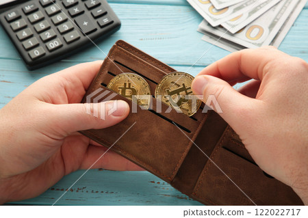 Businessman holding bitcoin. Golden bitcoin coins in man hands. Virtual currency. Crypto currency. New virtual money. Opened wallet. 122022717