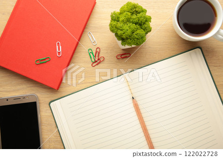 Open notebook with smartphone and cup of coffee on beige background. Open notebook with smartphone and cup of coffee on beige background. 122022728
