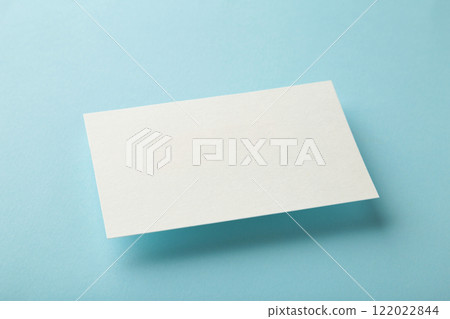 Blank white business card on blue paper background. Mockup for branding identity. Template for graphic designers portfolios. 122022844