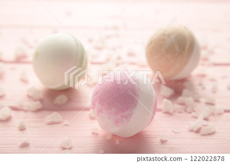 Composition with bath bombs and sea salt on wooden pink background. Composition with bath bombs and sea salt on wooden pink background. 122022878