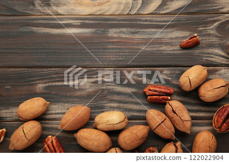 Pecan nuts on a brown wooden table. Top view. 122022904