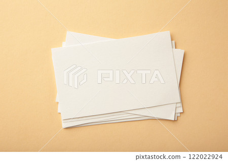 Blank white business cards on beige paper background. Mockup for branding identity. Template for graphic designers portfolios. Blank white business cards on beige paper background. Mockup for branding identity. Template for graphic designers portfolios. 122022924
