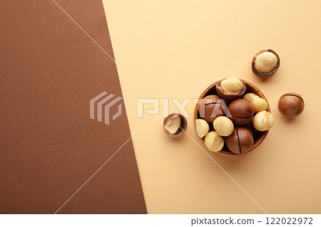 Macadamia nuts on brown and beige background. Top view. 122022972