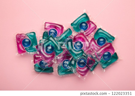 Laundry capsule detergent pods for washing clothes on pink background. 122023351