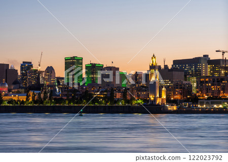 Old Port of Montreal and downtown skyline at night. Colorful buildings lights reflected in water. Montreal city, Quebec, Canada. Clock tower. Old Port of Montreal and downtown skyline at night. Colorful buildings lights reflected in water. Montreal city, Quebec, Canada. Clock tower. 122023792