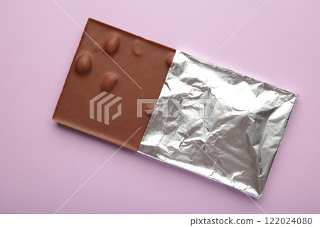 Chocolate wrapped in foil, clipping path on purple background. Chocolate wrapped in foil, clipping path on purple background. 122024080