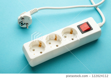 Electric white portable socket on blue background 122024112