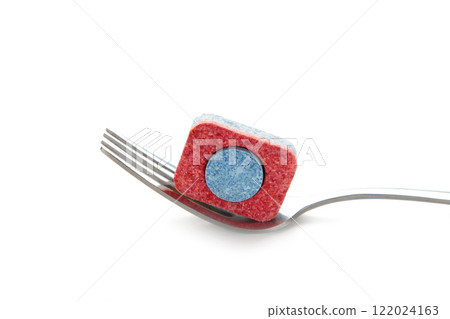 Dishwasher tablet on a fork isolated on a white background. Dishwasher tablet on a fork isolated on a white background. 122024163