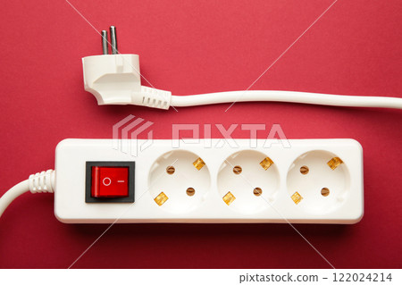 Electric white portable socket on red background 122024214
