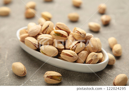 Pile of Pistachios ob white bowl isolated on white background. 122024295
